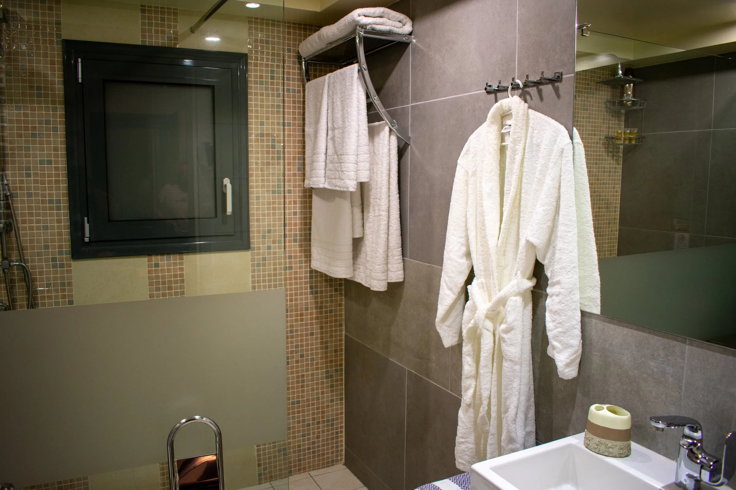 Bathroom with walk-in shower, bathrobe and towels