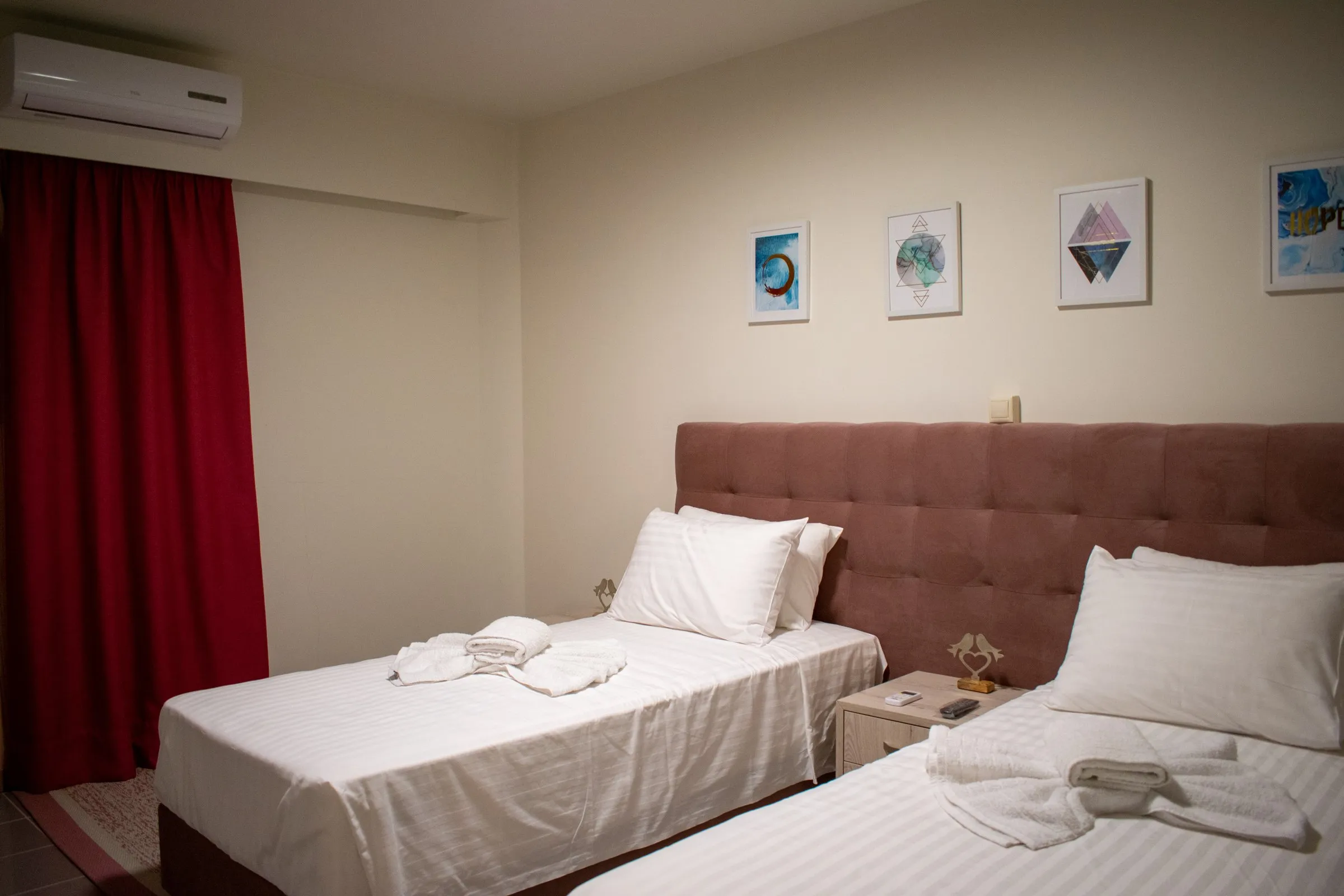 Twin room with framed prints above the beds